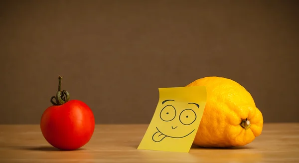 Lemon with post-it note sticking out tongue to tomato — Stock Photo, Image