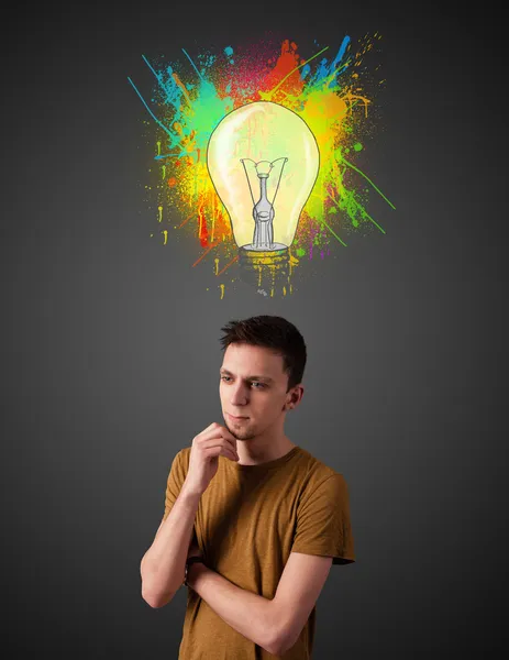 Young man thinking with lightbulb above his head — Stock Photo, Image