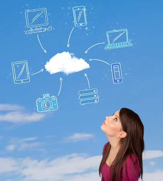Casual girl looking at cloud computing concept on blue sky — Stock Photo, Image