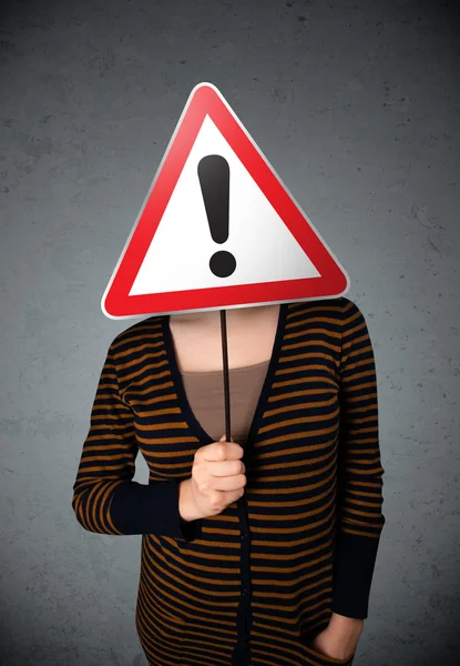 Young woman holding an exclamation road sign — Stock Photo, Image
