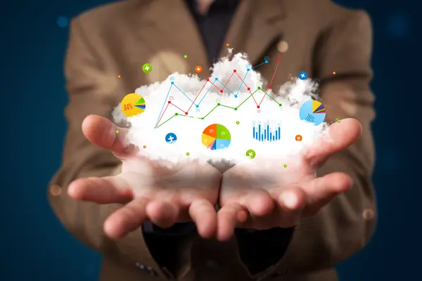 Young businessman presenting cloud with charts and graph icons a — Stock Photo, Image