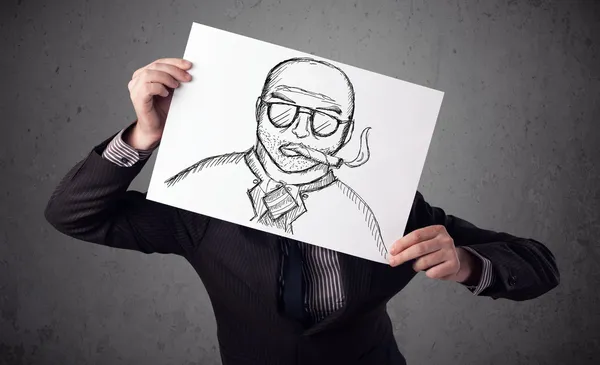 Businessman holding a cardboard with a smoking man on it in fron — Stock Photo, Image