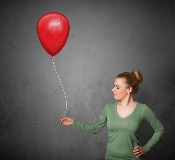 Frau mit rotem Luftballon — Stockfoto