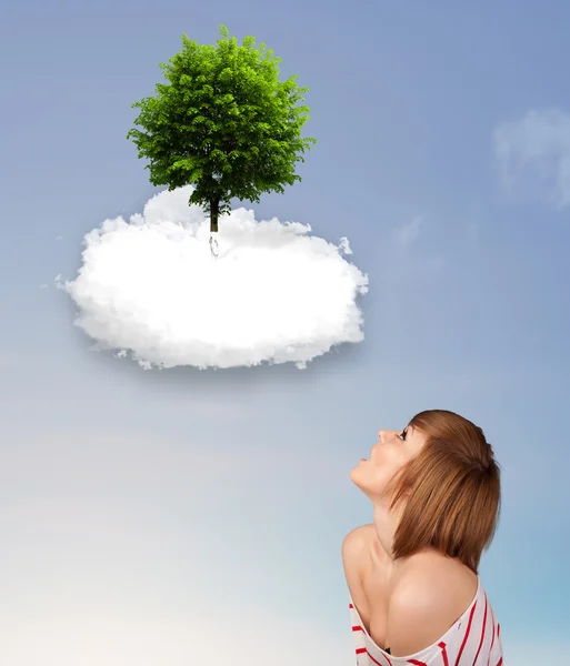 Niña apuntando a un árbol verde en la parte superior de una nube blanca — Foto de Stock