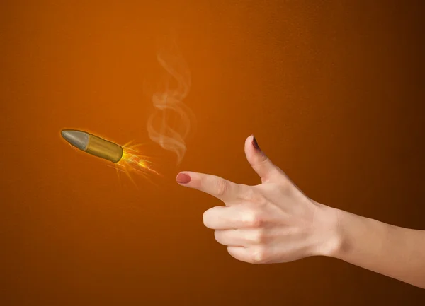 Gun shaped woman hand with bullet — Stock Photo, Image