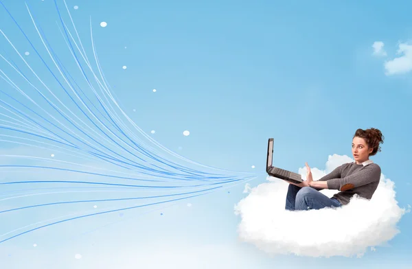 Young woman sitting in cloud with laptop — Stock Photo, Image