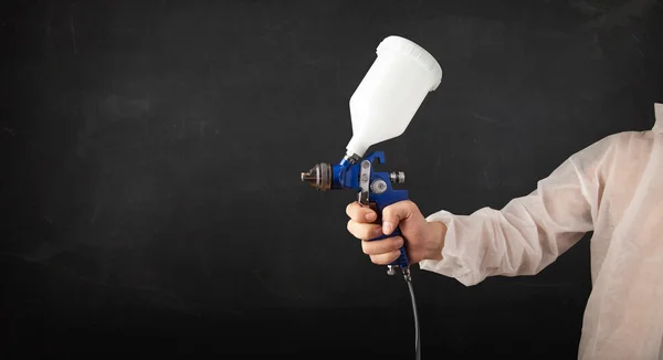 Painter works with airbrush gun and empty copyspace — Stock Photo, Image