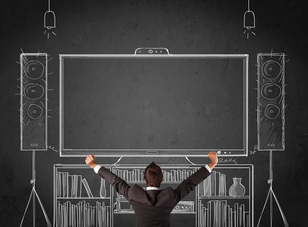 Businessman in front of a home cinema system — Stock Photo, Image