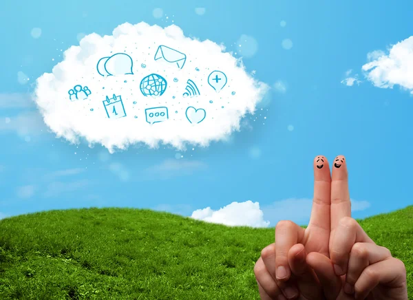 Happy smiley fingers looking at cloud with blue social icons and — Stock Photo, Image