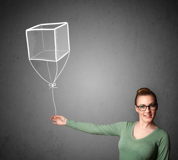 Donna in possesso di un palloncino cubo — Foto Stock