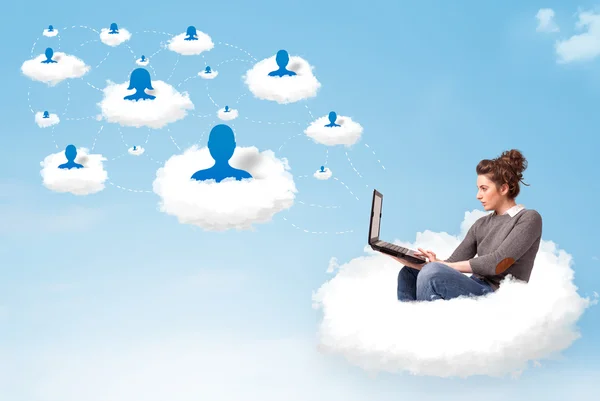 Young woman sitting in cloud with laptop — Stock Photo, Image