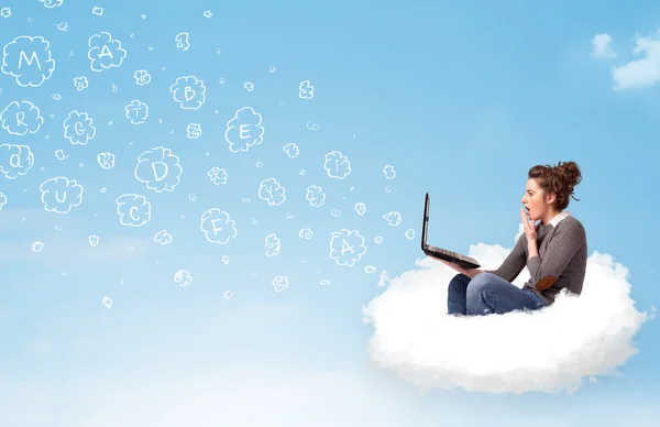 Young woman sitting in cloud with laptop — Stock Photo, Image