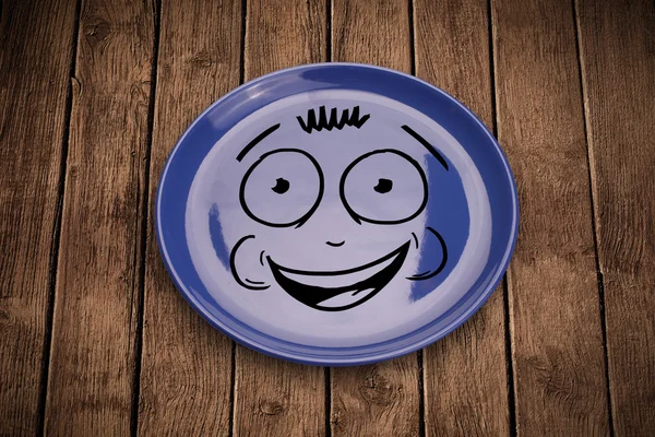 ハッピースマイリー漫画の顔上のカラフルな皿 — ストック写真
