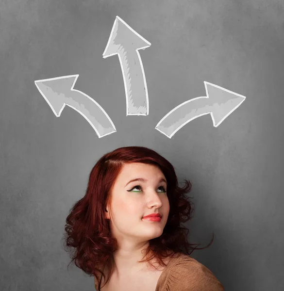Young woman thinking with arrows above her head — Stock Photo, Image
