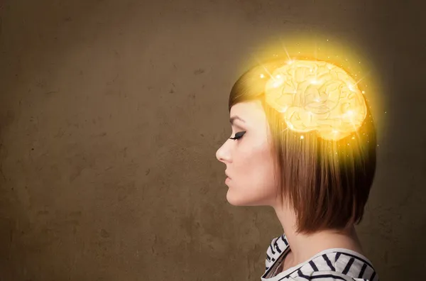 Young girl thinking with glowing brain illustration — Stock Photo, Image