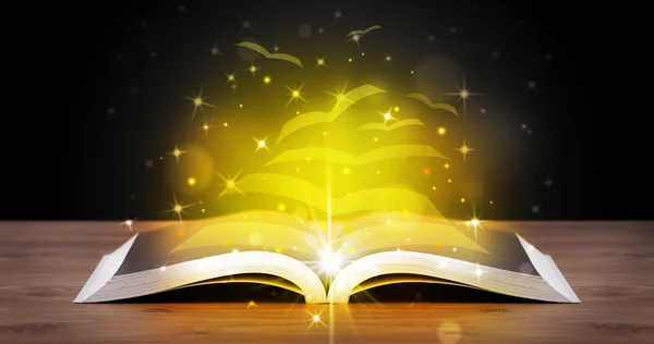 Open book with golden glow flying paper pages — Stock Photo, Image