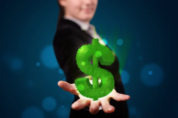 Młoda kobieta prezentuje zielony świecący znak dolara — Zdjęcie stockowe