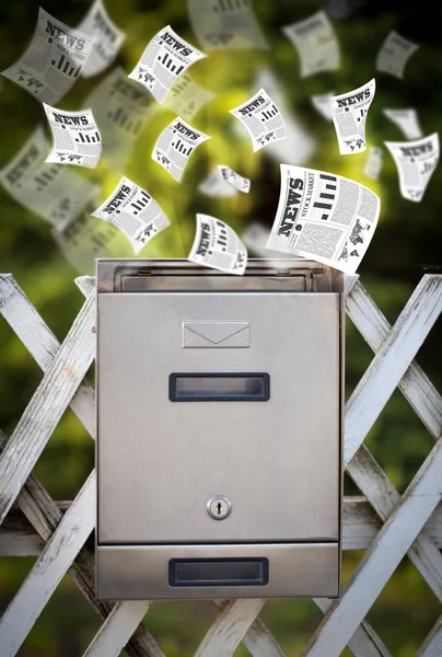 Post box with daily newspapers flying — Stock Photo, Image