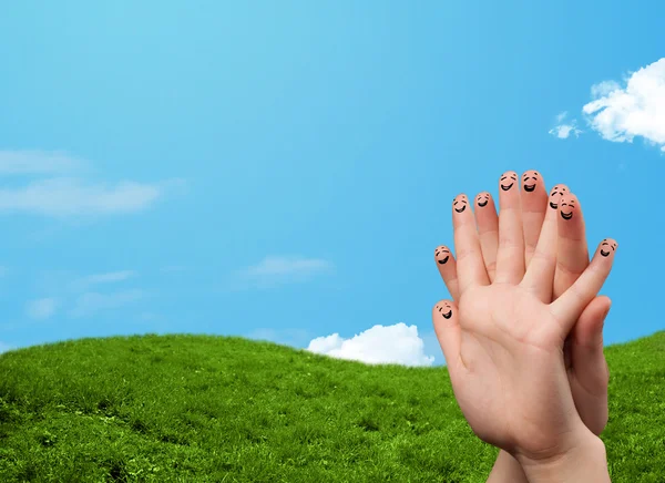 Cheerful finger smileys with landscape scenery at the background — Stock Photo, Image