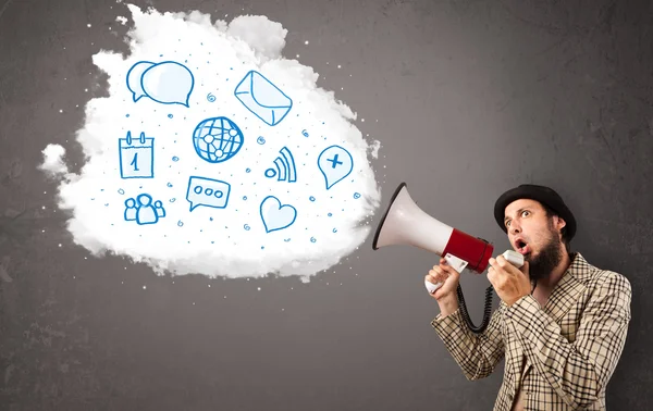 Man shouting into loudspeaker and modern blue icons and symbols — Stock Photo, Image