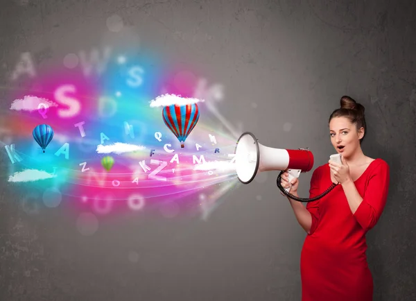 Girl shouting into megaphone and abstract text and balloons come — Stock Photo, Image