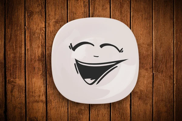 Счастливое карикатурное лицо на цветной тарелке — стоковое фото