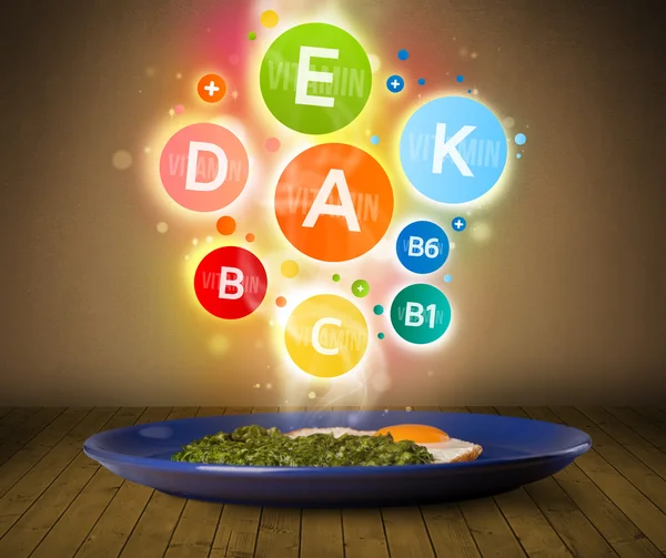 Food plate with delicious meal and healthy vitamin symbols — Stock Photo, Image