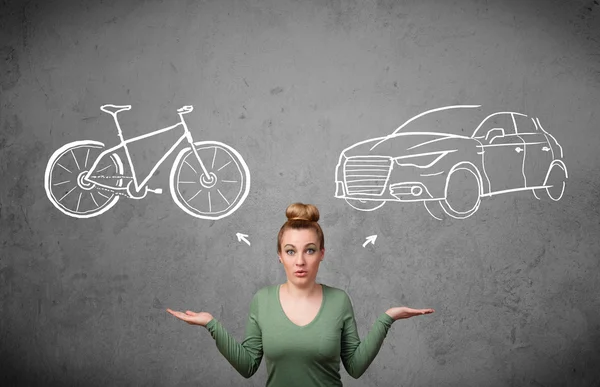 Woman making a choice between bicycle and car — Stock Photo, Image