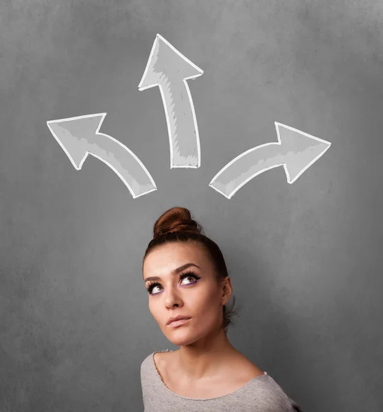 Young woman thinking with arrows above her head — Stock Photo, Image