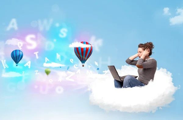 Young woman sitting in cloud with laptop — Stock Photo, Image