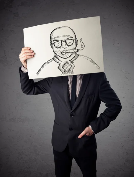 Businessman holding a cardboard with a smoking man on it in fron — Stock Photo, Image
