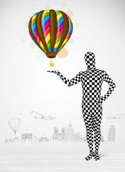 Man in full body suit holding balloon — Stock Photo, Image