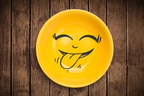 Happy smiley cartoon face on colorful dish plate — Stock Photo, Image