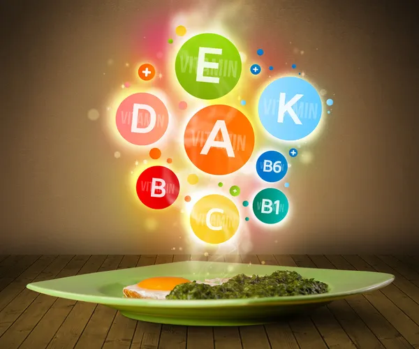 Food plate with delicious meal and healthy vitamin symbols — Stock Photo, Image