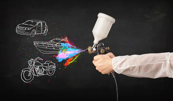Man with airbrush spray paint with car, boat and motorcycle draw — Stock Photo, Image