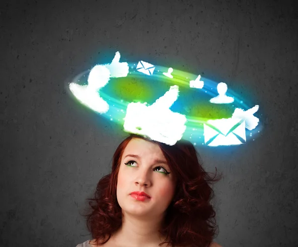 Young teenager with cloud social icons around her head — Stock Photo, Image