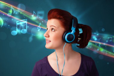 Kulaklıkla müzik dinleyen genç bir kadın.