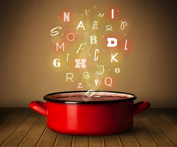 Glowing letters coming out from cooking pot — Stock Photo, Image