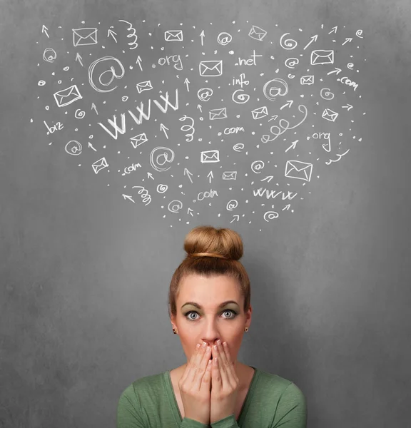 Young woman thinking with social network icons above her head — Stock Photo, Image