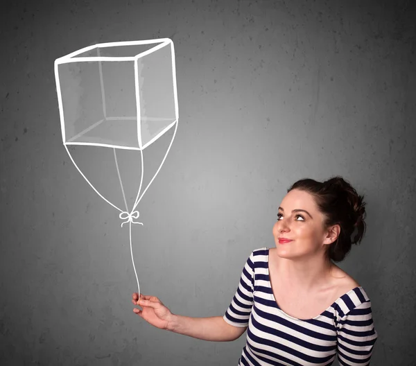 Mulher segurando um balão cubo — Fotografia de Stock