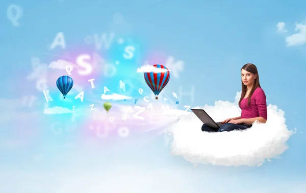 Young woman sitting in cloud with laptop — Stock Photo, Image