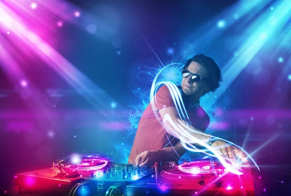 Dj energetico che mescola musica con potenti effetti di luce — Foto Stock