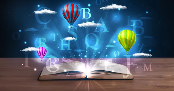 Open book with glowing fantasy abstract clouds and balloons — Stock Photo, Image