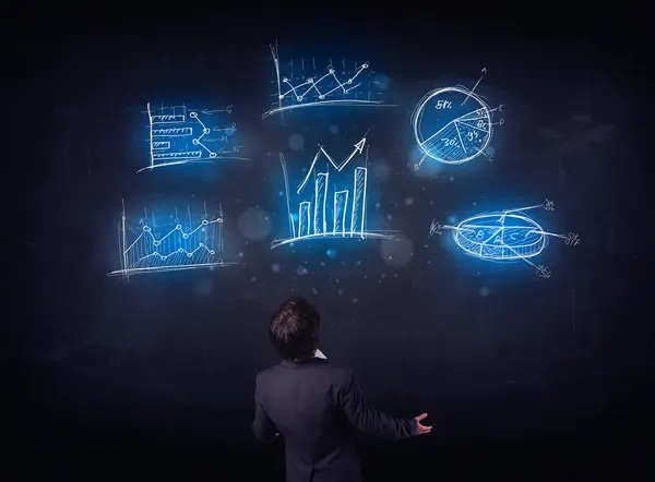 Businessman looking at glowing charts — Stock Photo, Image