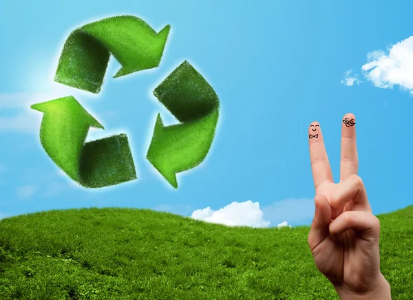 Happy smiley fingers looking at green leaf recycle sign — Stock Photo, Image