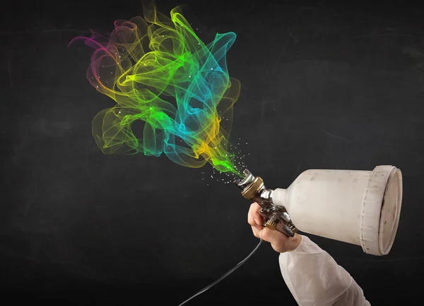 Painter working with airbrush and paints colorful paint — Stock Photo, Image