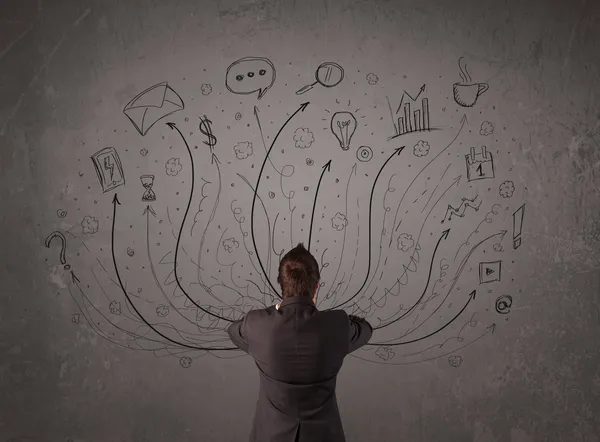 Businessman in front of a chalkboard deciding with arrows and si — Stock Photo, Image