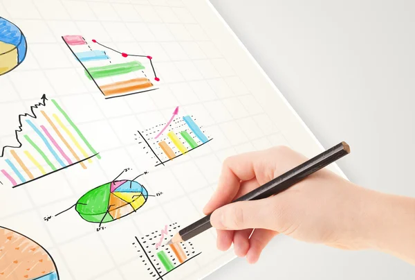 Business person drawing colorful graphs and icons on paper — Stock Photo, Image