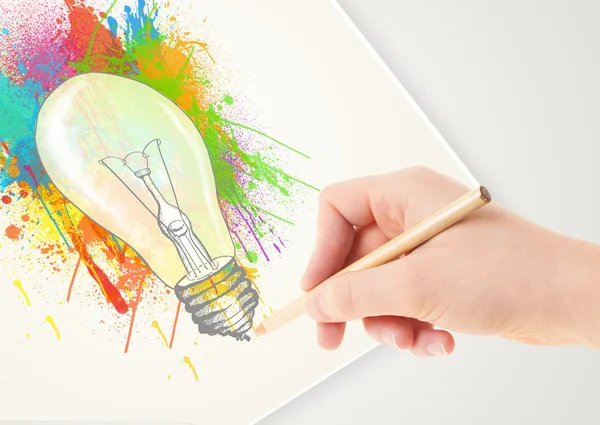 Hand drawing on paper a colorful splatter lightbulb — Stock Photo, Image