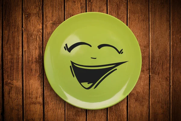 Happy smiley cartoon face on colorful dish plate — Stock Photo, Image